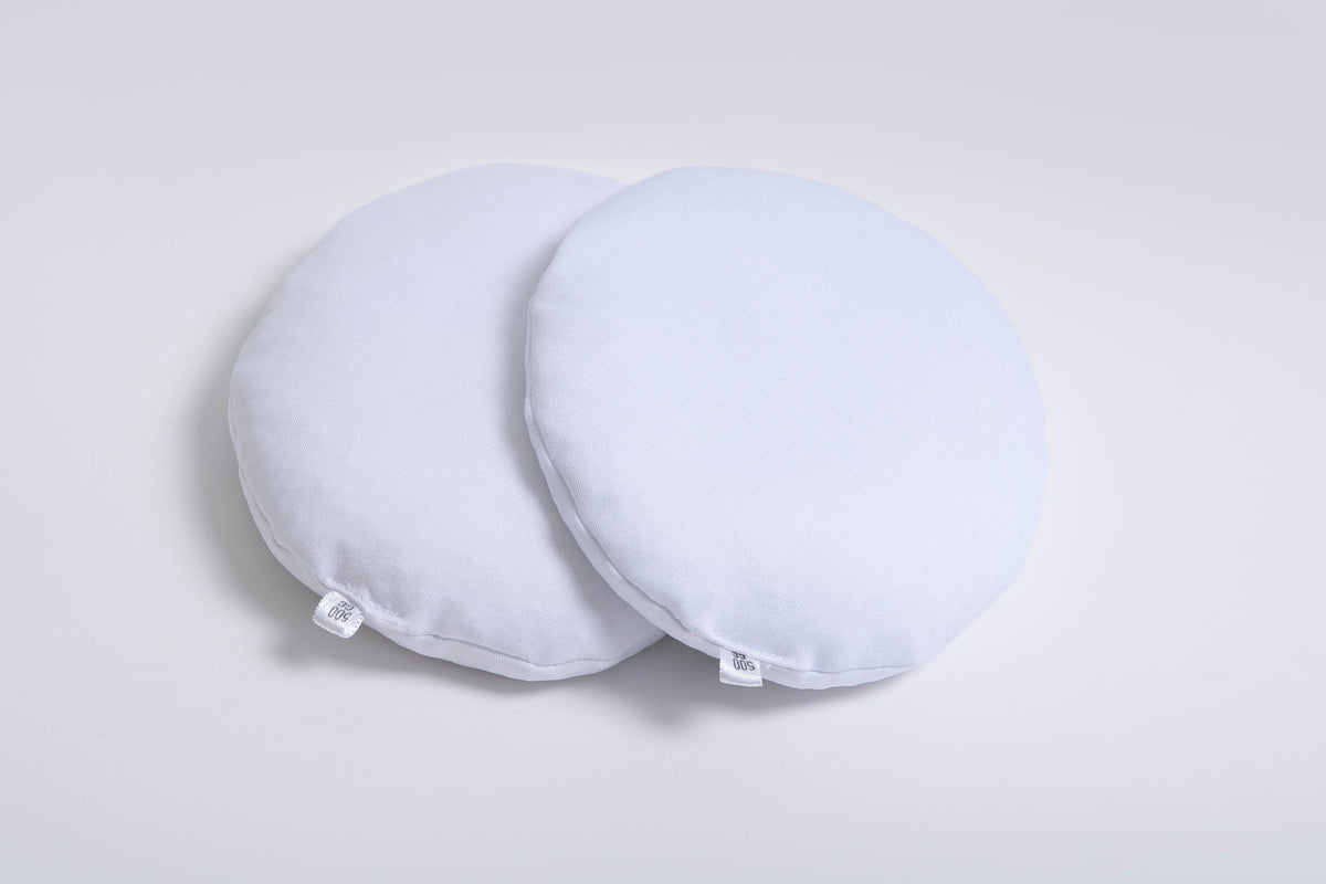 Pair of Oumènta breast implant sizers designed to help women try on and compare breast implant sizes at home before breast augmentation surgery.